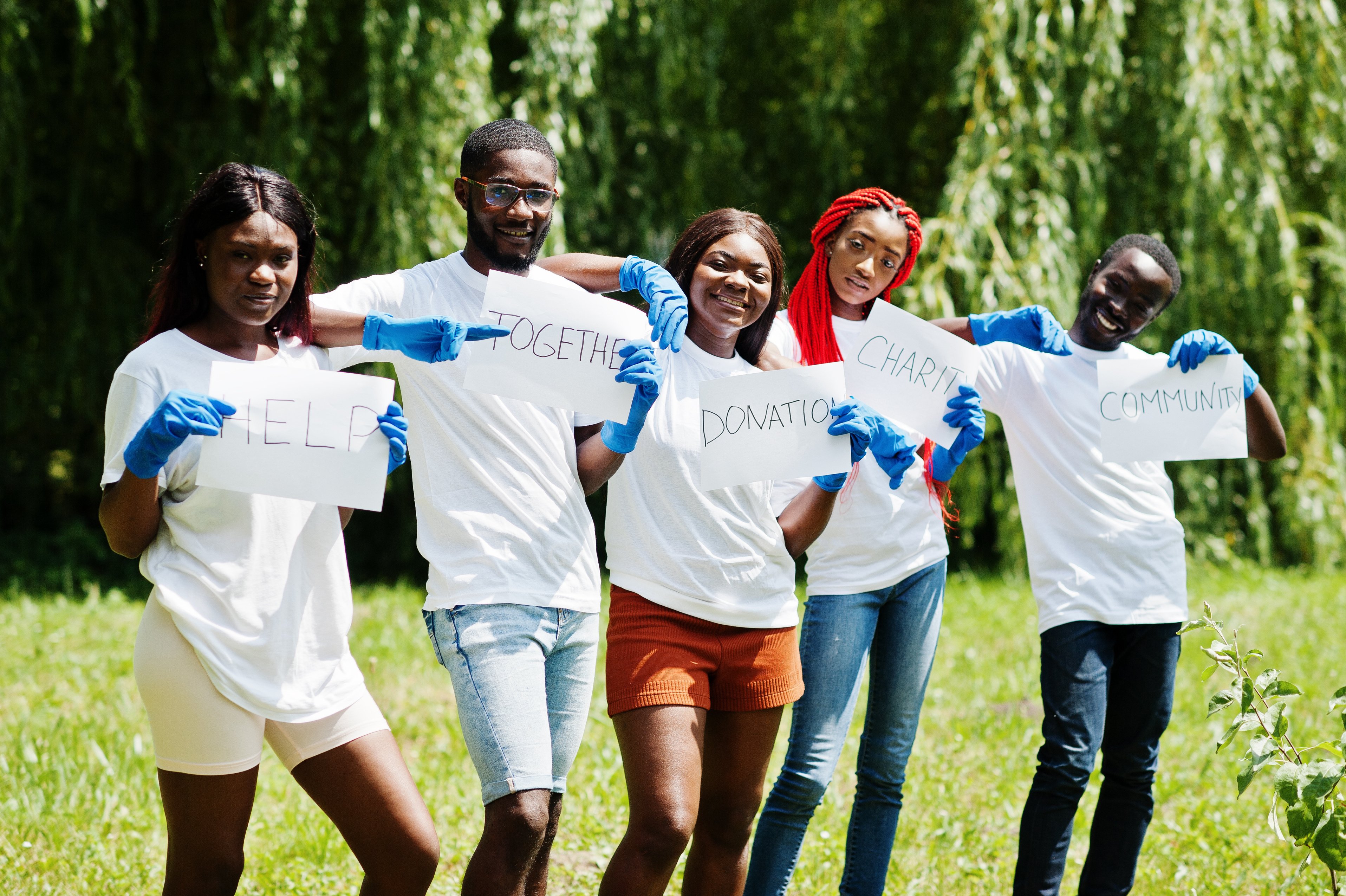 Group of happy african volunteers. Africa volunteering, charity, people and ecology concept.